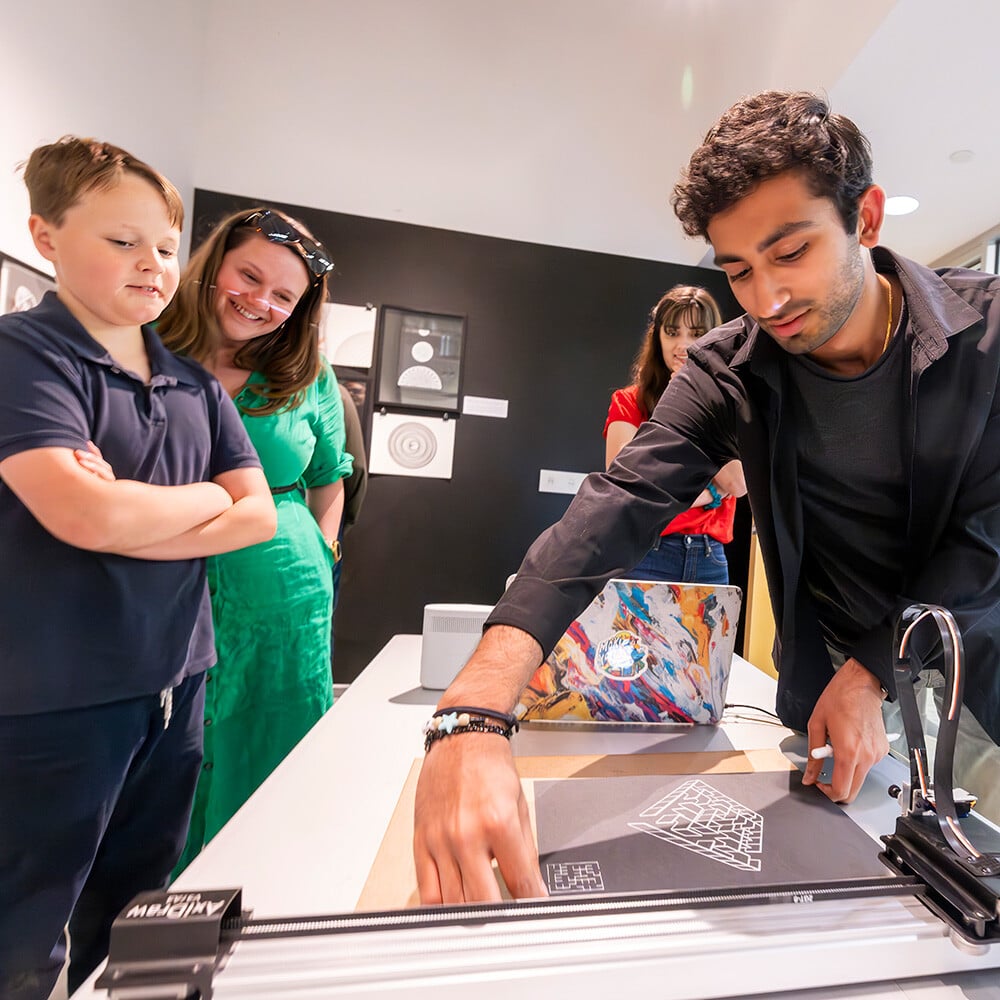 Man shows child art equipmenr Man shows child art equipmenr